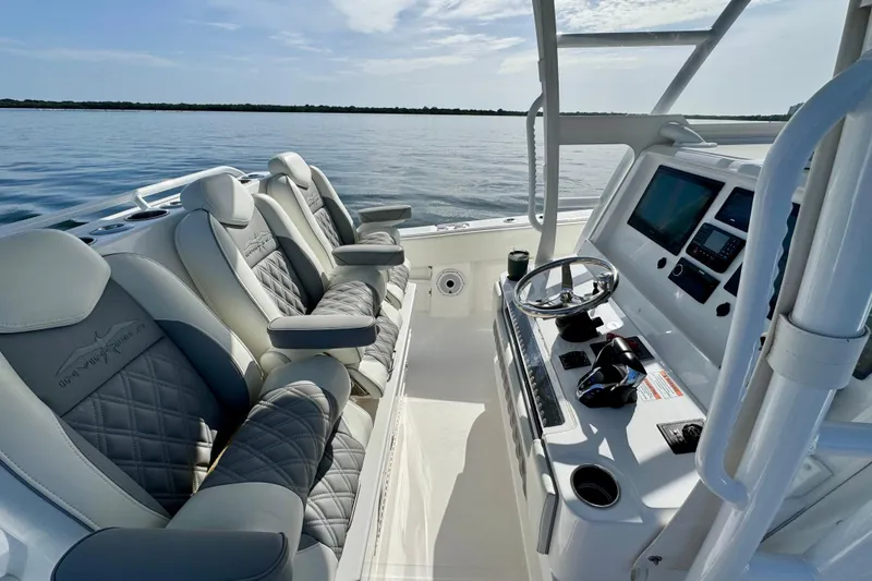 Slide: The Image of 2024 Invincible 39 Open Fisherman boat interior with luxury seating and modern dashboard. - 6