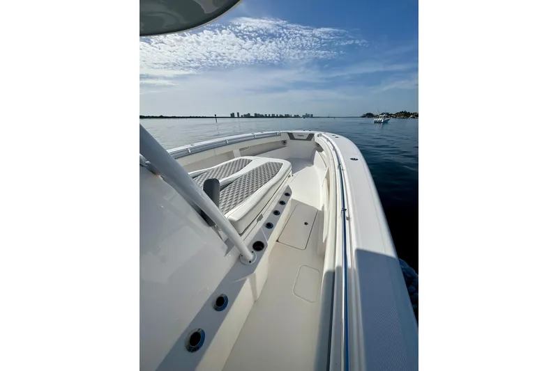 Slide: The Image of 2024 Invincible 39 Open Fisherman boat on calm water, showcasing sleek design and spacious deck. - 9