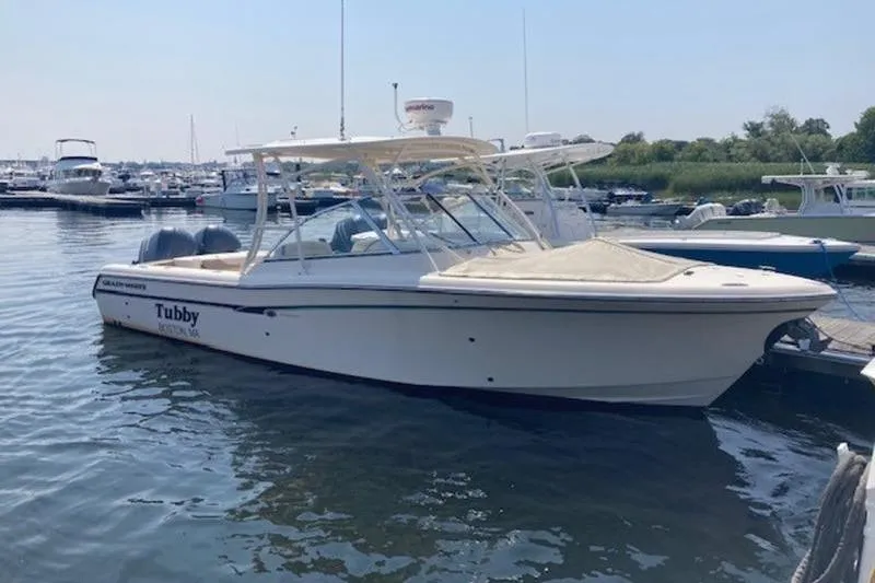 The Image of 2014 Grady-White Freedom 285 boat docked in a marina, side view. - 1