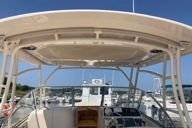 Slide: The Image of 2014 Grady-White Freedom 285 boat interior with helm, docked at marina. - 15