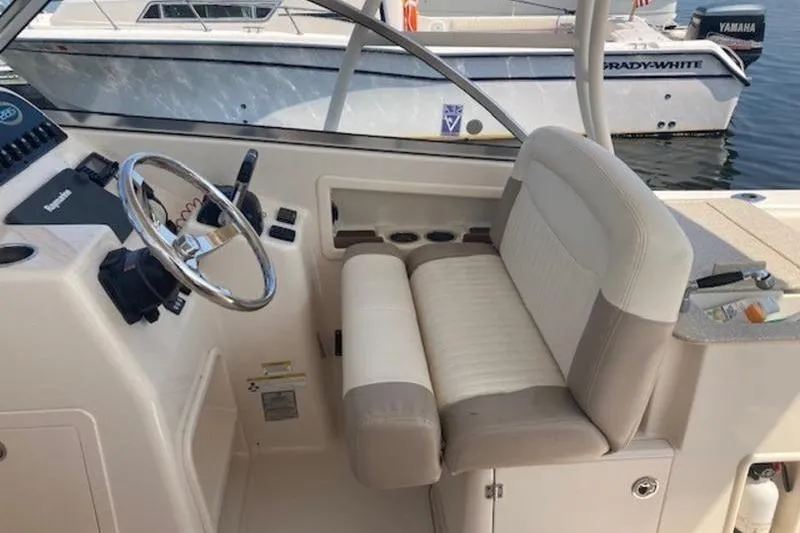 Slide: The Image of 2014 Grady-White Freedom 285 boat interior with steering wheel and seating. - 16