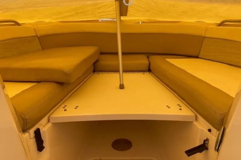 Slide: The Image of 2014 Grady-White Freedom 285 boat interior with cushioned seating and table. - 17