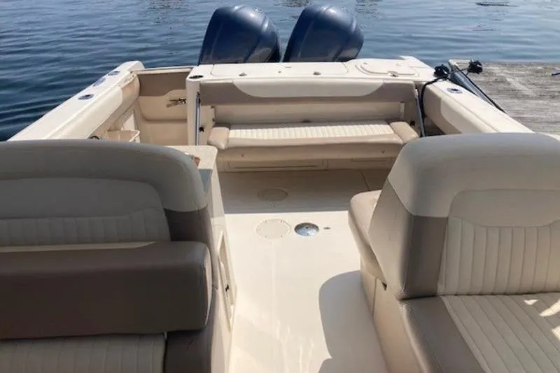 Slide: The Image of 2014 Grady-White Freedom 285 boat interior with seating and twin engines. - 3