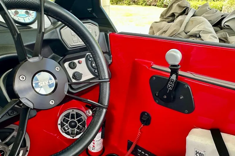 Slide: The Image of 2021 Axis A20 boat dashboard with steering wheel and control panel. - 19