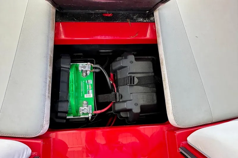 Slide: The Image of Battery compartment of a 2021 Axis A20 boat, featuring a green battery and secure black casing. - 27