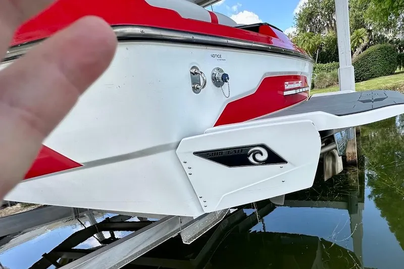Slide: The Image of 2021 Axis A20 boat rear view with red accents and Surf Gate feature. - 36