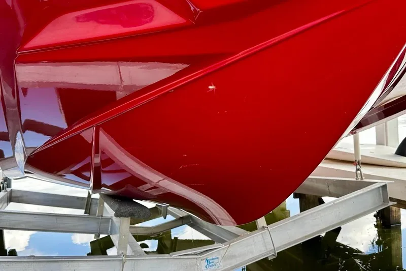 Slide: The Image of Red 2021 Axis A20 boat hull on trailer, reflecting water below. - 42