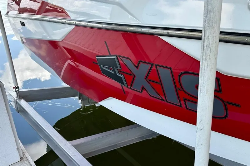 Slide: The Image of 2021 Axis A20 boat with red and white design on a lift. - 43