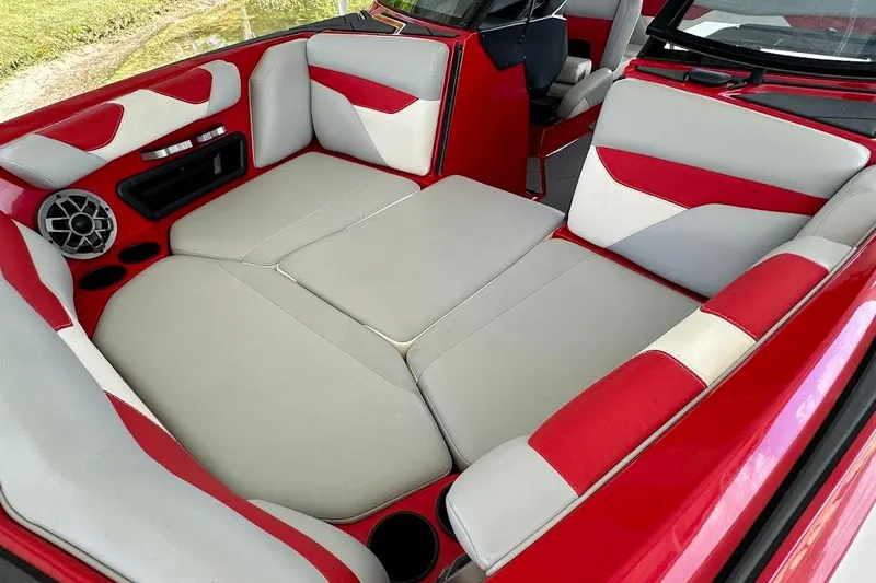 Slide: The Image of 2021 Axis A20 boat interior with red and white seating and speaker system. - 46