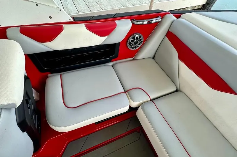 Slide: The Image of 2021 Axis A20 boat interior with red and white seating and speaker detail. - 9