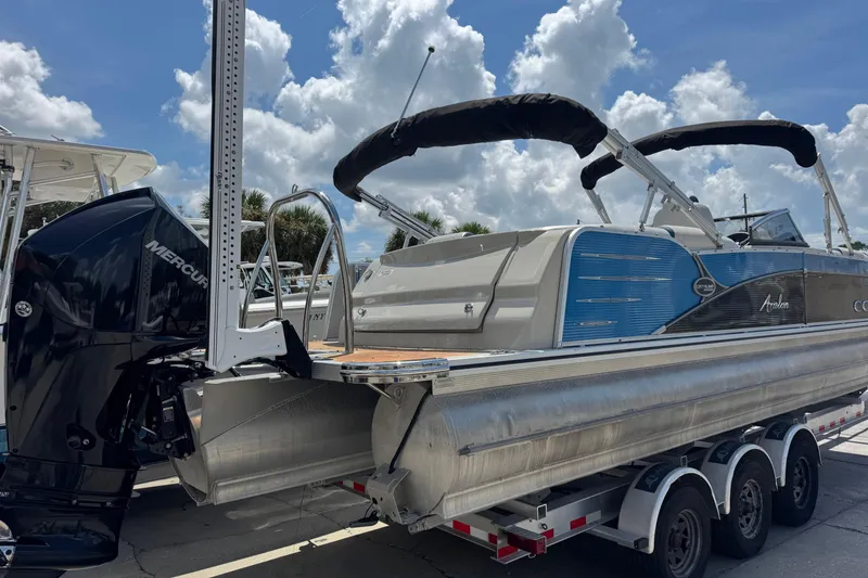 Slide: The Image of 2019 Avalon Catalina Platinum Elite pontoon boat with Mercury engine on trailer. - 11