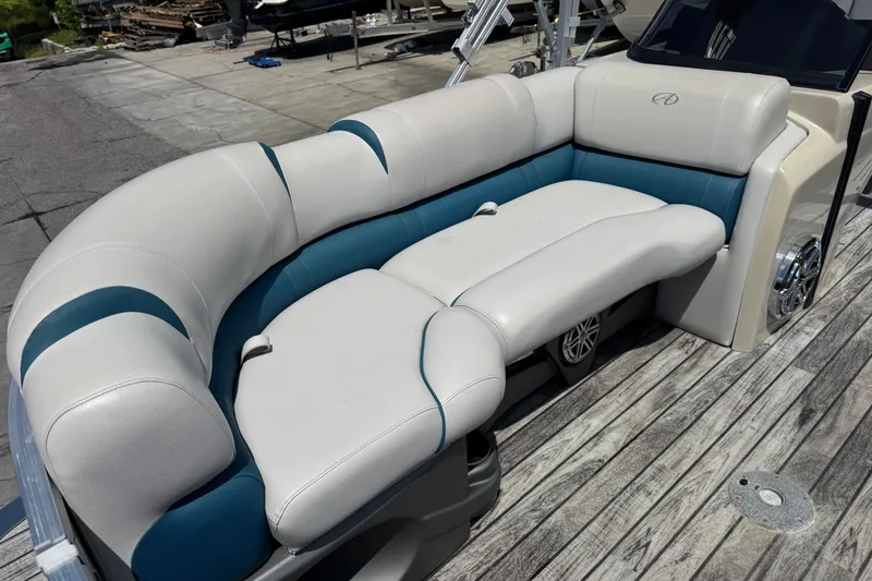 Slide: The Image of 2019 Avalon Catalina Platinum Elite boat seating with white and blue upholstery on deck. - 15