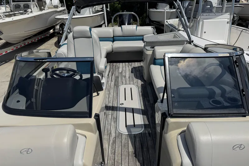Slide: The Image of 2019 Avalon Catalina Platinum Elite Windshield boat interior with luxurious seating and sleek design. - 17