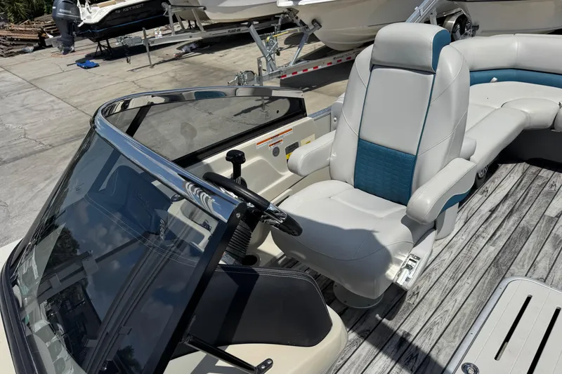 Slide: The Image of 2019 Avalon Catalina Platinum Elite boat interior with captain's chair and windshield. - 19