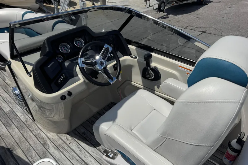 Slide: The Image of 2019 Avalon Catalina Platinum Elite boat interior with steering wheel and dashboard. - 24
