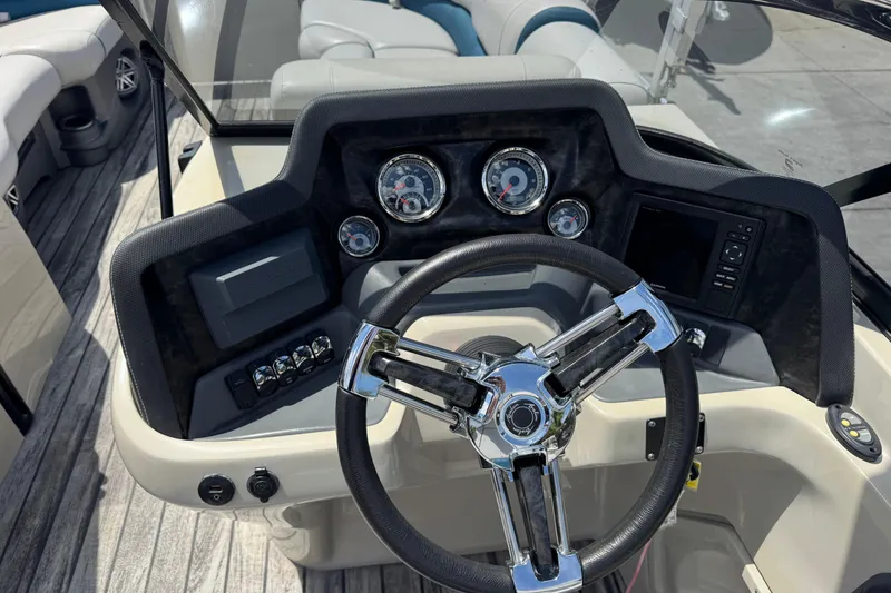 Slide: The Image of Steering console of 2019 Avalon Catalina Platinum Elite Windshield boat, featuring modern controls and gauges. - 25