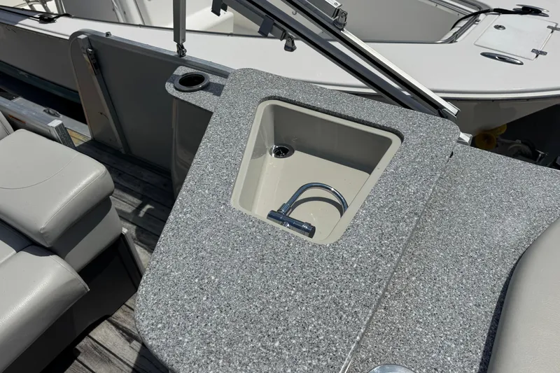Slide: The Image of 2019 Avalon Catalina Platinum Elite boat sink and seating area. - 28