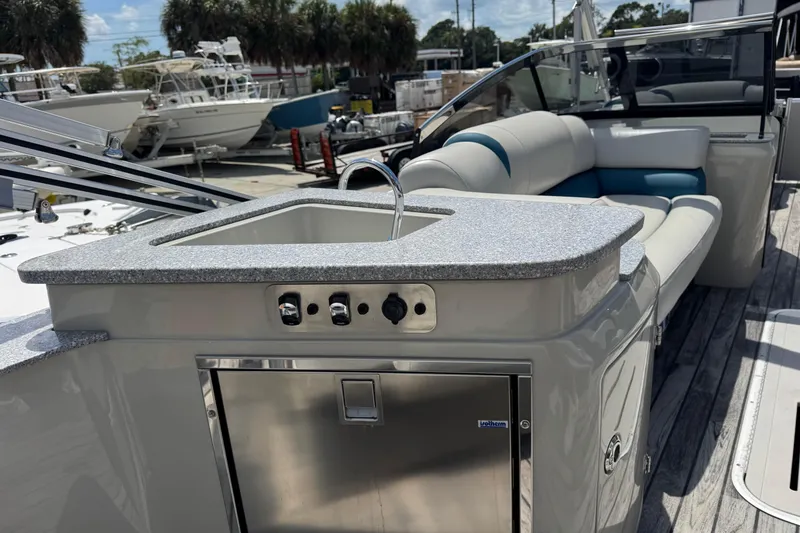 Slide: The Image of 2019 Avalon Catalina Platinum Elite boat interior with sink and seating area. - 30