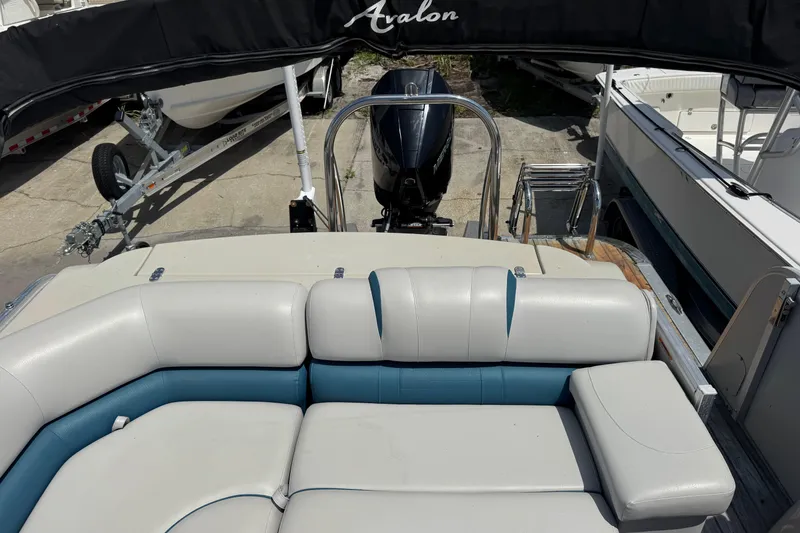 Slide: The Image of 2019 Avalon Catalina Platinum Elite boat interior with seating and motor view. - 31