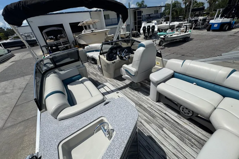 Slide: The Image of 2019 Avalon Catalina Platinum Elite Windshield boat interior with seating and steering console. - 35