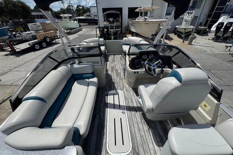 Slide: The Image of 2019 Avalon Catalina Platinum Elite Windshield boat interior with seating and steering console. - 36
