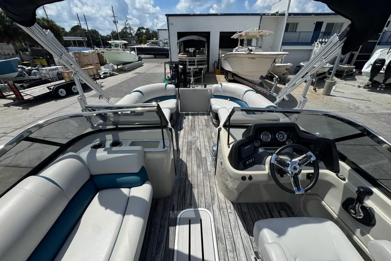 Slide: The Image of 2019 Avalon Catalina Platinum Elite boat interior with steering wheel and seating. - 37