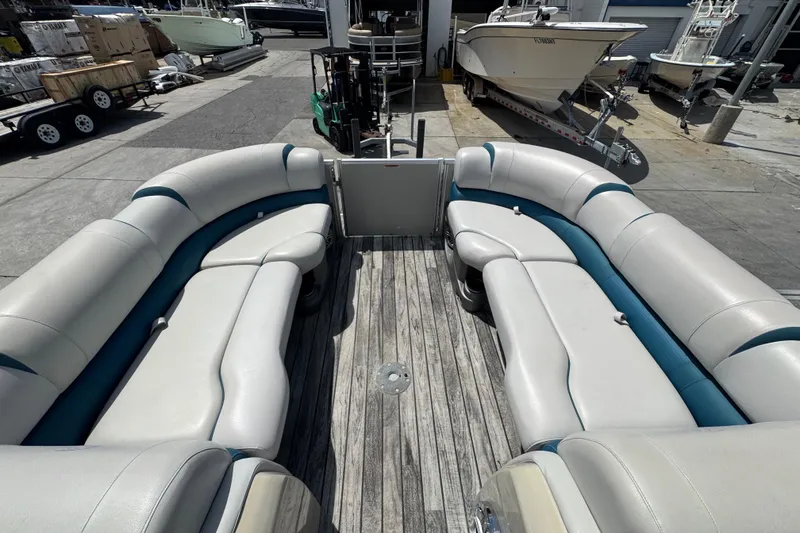 Slide: The Image of 2019 Avalon Catalina Platinum Elite boat interior with spacious seating and wooden deck. - 39