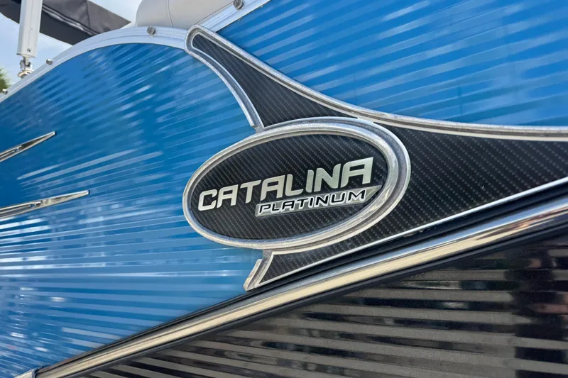 Slide: The Image of 2019 Avalon Catalina Platinum Elite boat emblem on blue exterior. - 8