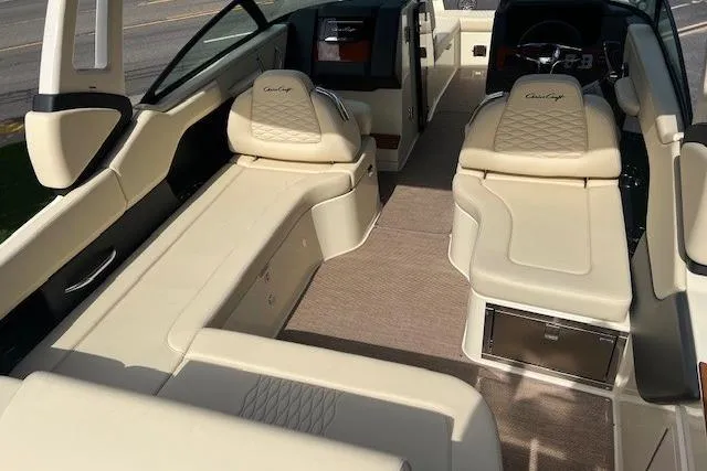 Slide: The Image of 2026 Chris-Craft Sportster 28 interior with luxurious beige seating and modern dashboard. - 10