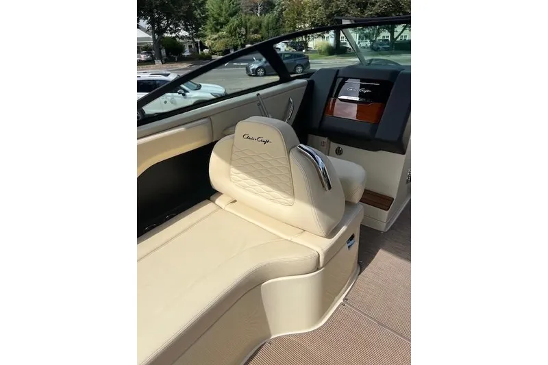 Slide: The Image of 2026 Chris-Craft Sportster 28 interior with beige leather seating and elegant dashboard. - 12
