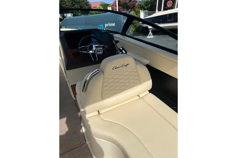 Slide: The Image of 2026 Chris-Craft Sportster 28 interior with luxurious cream leather seating and sleek dashboard. - 13