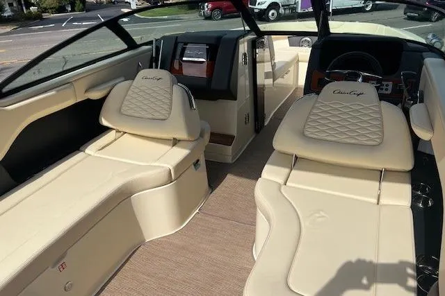 Slide: The Image of 2026 Chris-Craft Sportster 28 interior with luxurious beige seating and modern dashboard. - 14