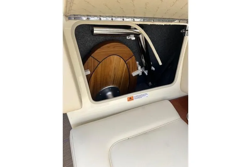 Slide: The Image of 2026 Chris-Craft Sportster 28 interior storage compartment with wooden paneling. - 18