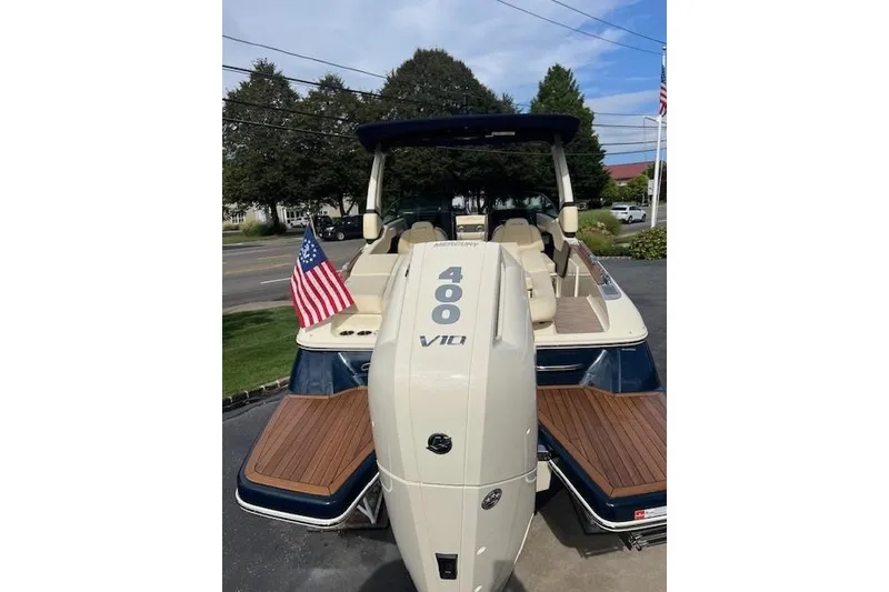 Slide: The Image of 2026 Chris-Craft Sportster 28 with Mercury 400 V10 engine, American flag displayed. - 2