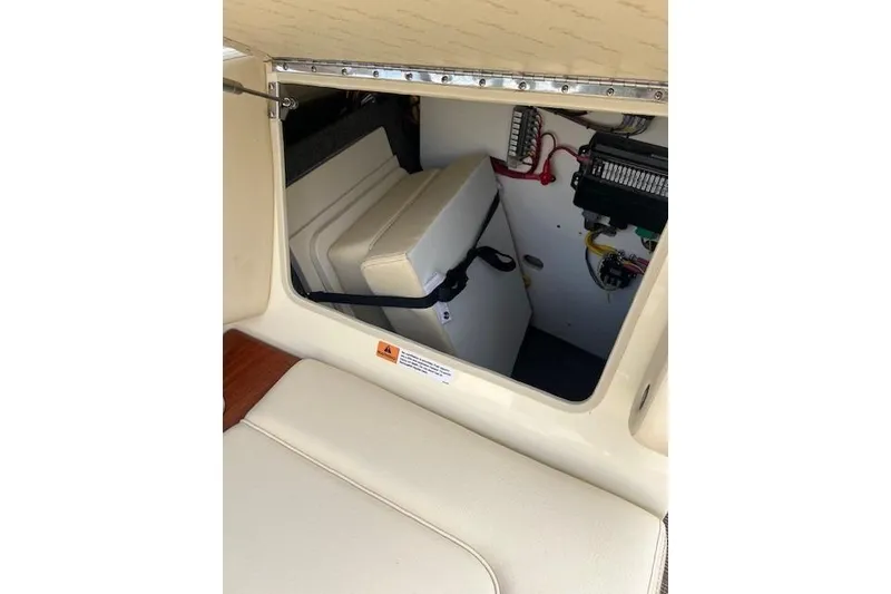 Slide: The Image of 2026 Chris-Craft Sportster 28 interior storage compartment with electrical components. - 20