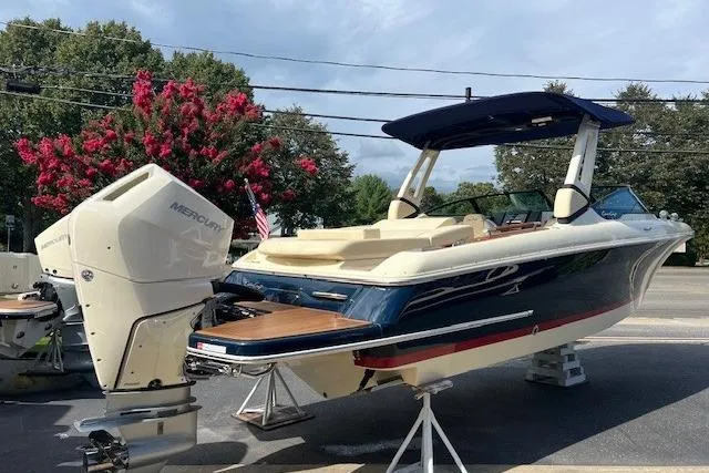 Slide: The Image of 2026 Chris-Craft Sportster 28 boat with Mercury outboard engine, displayed outdoors. - 4