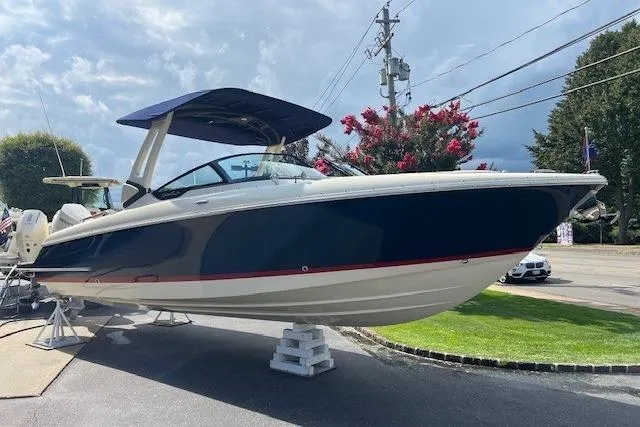 Slide: The Image of 2026 Chris-Craft Sportster 28 boat displayed outdoors on a stand. - 5