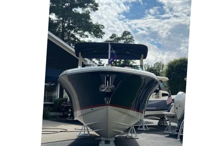 Slide: The Image of 2026 Chris-Craft Sportster 28 boat displayed outdoors under a cloudy sky. - 6