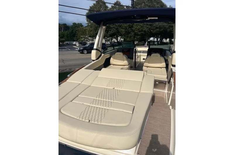 Slide: The Image of 2026 Chris-Craft Sportster 28 boat interior with beige seating and modern design. - 8