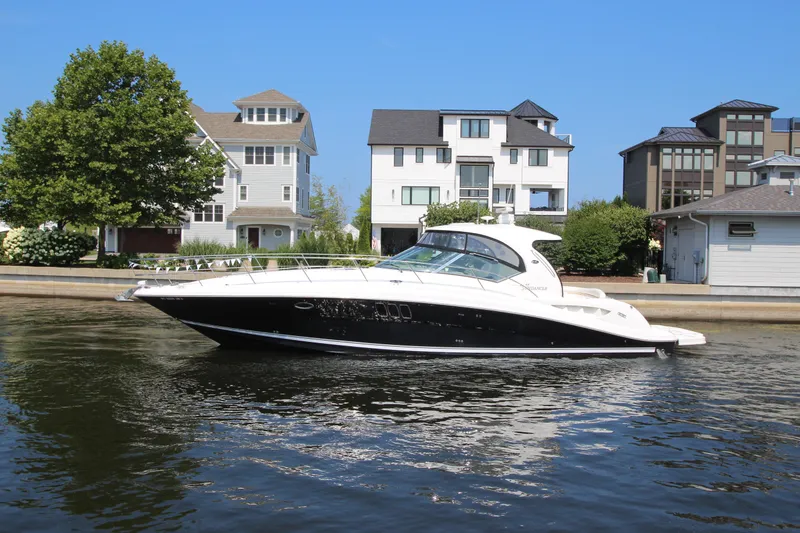The Image of 2008 Sea Ray 44 Sundancer yacht docked near waterfront homes. - 0