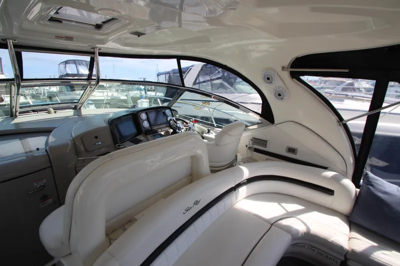Slide: The Image of 2008 Sea Ray 44 Sundancer yacht interior with helm, seating, and navigation equipment. - 11