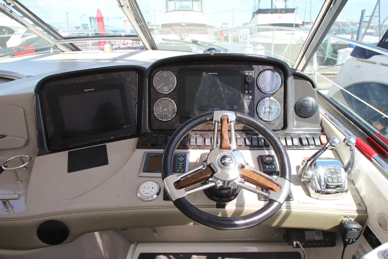 Slide: The Image of 2008 Sea Ray 44 Sundancer helm with steering wheel, navigation screens, and control panel. - 15
