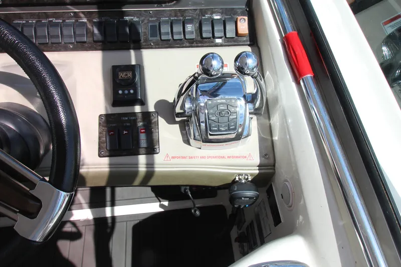 Slide: The Image of Control panel of a 2008 Sea Ray 44 Sundancer boat with steering wheel and throttle controls. - 19