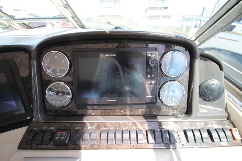 Slide: The Image of Dashboard of a 2008 Sea Ray 44 Sundancer with gauges and Raymarine display. - 20
