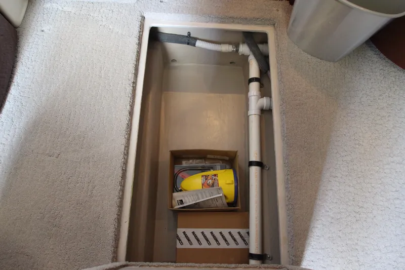 Slide: The Image of Storage compartment in 2008 Sea Ray 44 Sundancer with plumbing and equipment. - 26