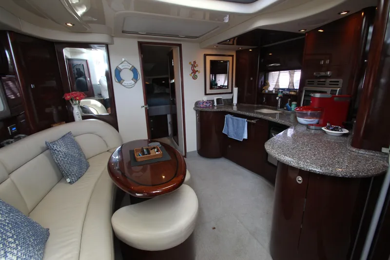 Slide: The Image of Luxurious interior of 2008 Sea Ray 44 Sundancer yacht with elegant seating and modern kitchen. - 44