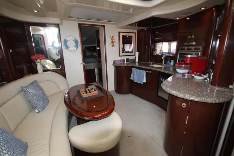 Slide: The Image of Luxurious interior of 2008 Sea Ray 44 Sundancer yacht with elegant seating and modern kitchen. - 45