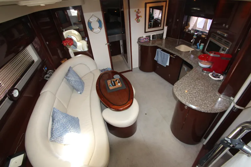Slide: The Image of Luxurious 2008 Sea Ray 44 Sundancer interior with elegant seating and modern kitchen amenities. - 49