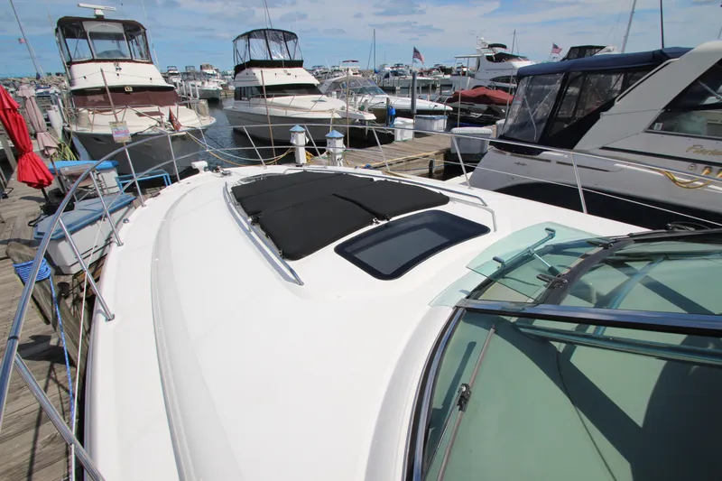 Slide: The Image of 2008 Sea Ray 44 Sundancer yacht docked at marina, surrounded by other boats. - 54