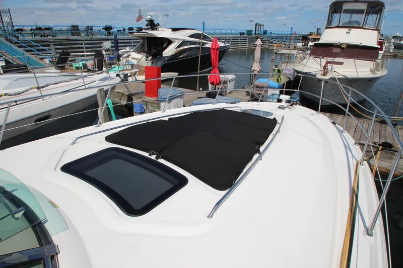 Slide: The Image of 2008 Sea Ray 44 Sundancer yacht docked at marina, featuring sleek design and sunroof. - 57